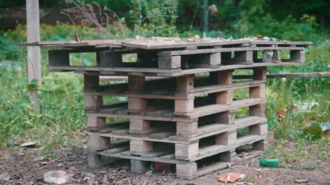 Parallax Side Shot: Abandoned Makeshift Picnic Table Made from Old Wooden Pallet Stock Footage 335249720