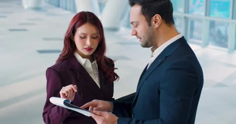 Parallax Slow Motion Shot Two Business People Reviewing Documents in Colorful Vidéo 331900131