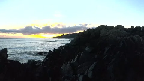 Parallax view of Sun setting through the clouds and scattering lights with Stock Footage 264236610