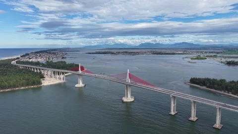 Parallel aerial alongside Thuan An Bridge 4K Stock Footage 339861204