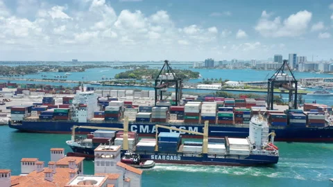 Parallel aerial shot of heavy loaded cargo ship entering harbor. Containers 4K Stock-Footage 149995435