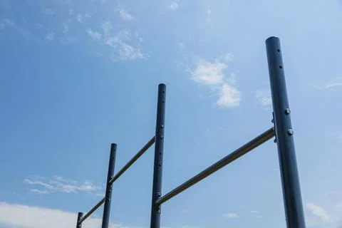 Parallel bars stand in a sunlit gym setting, inviting users to practice exe.. Stock Photos