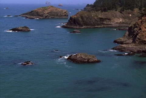 Parallel to the cliffs along the coast, the flight passes next to massive rock Video stock 86832545