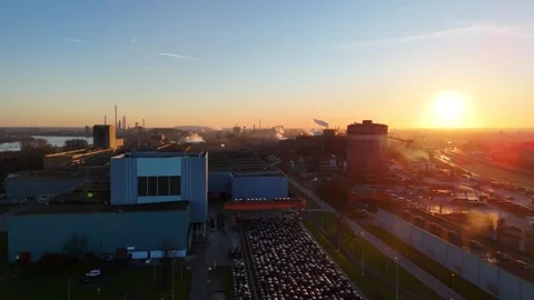 Parallel dawn flight past smoking industrial structures Stock Footage 331202522