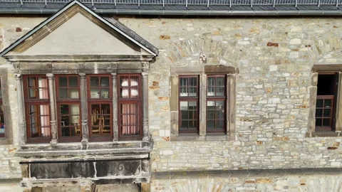 Parallel drift past ornate bay window on castle wall 库存影片 332380624