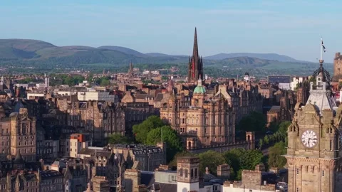 Parallel Drone Flight Along Edinburgh Old Town Revealing the Balmoral Clock Video stock 315664021
