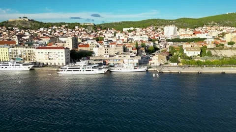 Parallel drone flight, next to a small croatian city. In the foreground is Stock-Footage 297469461