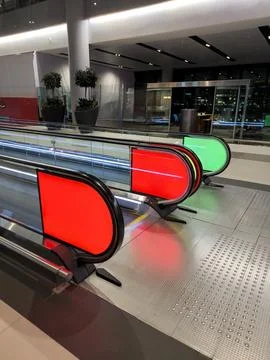 Parallel escalators with lighting: red and green Stock Photos