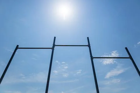 Parallel horizontal bars stand tall against a blue sky, perfect for various.. Foto stock