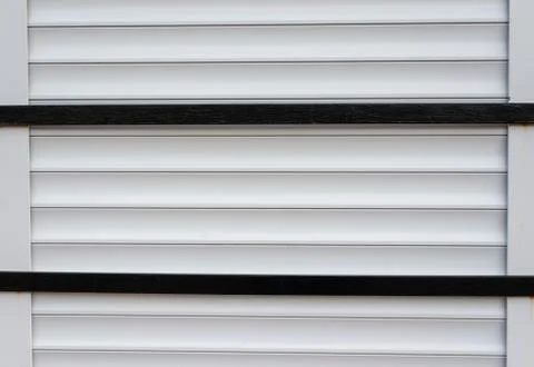 Parallel horizontal metal blinds with two black bars across Stock Photos