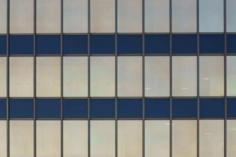 Parallel lines intersect perpendicularly and divide the windows of a modern b 写真素材