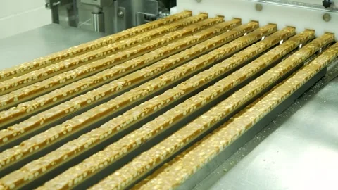 Parallel lines of nougat bars filled with roasted peanuts Stock Footage 330477976