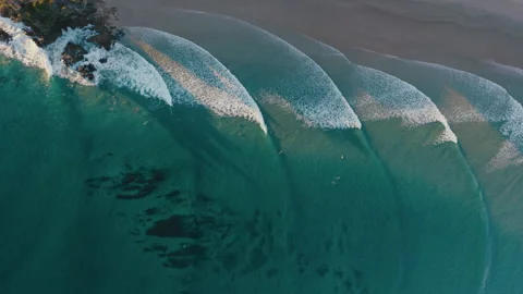 Parallel Ocean Waves Rolling Toward a Quiet Sandy Beach Stock Footage 328699739