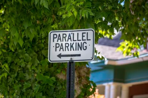 Parallel parking sign with tree Stock Photos