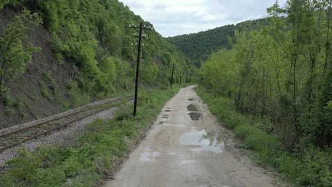 Parallel railroad track and dirt road in the wild 4K drone video Stock Footage 113885885