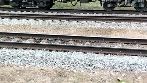 Parallel railway tracks with visible train wheels at station slow pan left calm Stock-Footage 326209921
