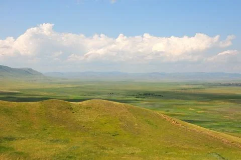Parallel rows of rocky formations running down the slope of a gentle hill o.. Stockfoto's