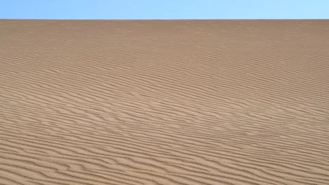 Parallel sand lines mark dune surface with rhythmic desert texture and arid 動画素材 333861207