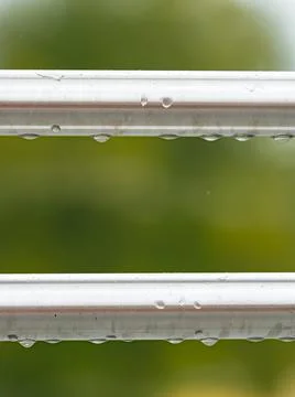 Parallel stainless bars outdoors with raindrops Stock Photos