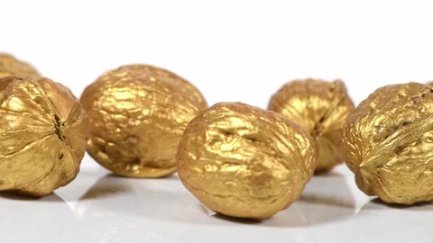 Parallel tracking of golden walnuts on a white background Video stock 142590687
