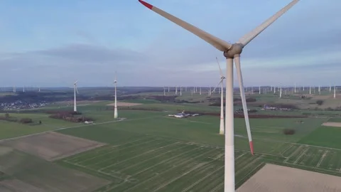 Parallel tracking past turbine rows over rural fields Stock-Footage 331212776