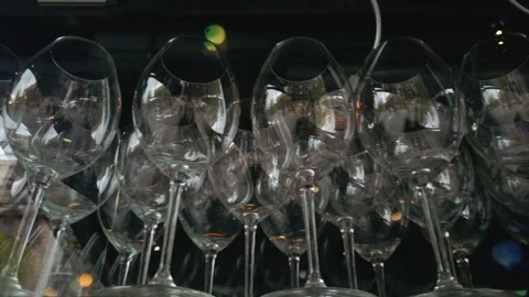 Parallel tracking shot of neatly arranged empty wine glasses, capturing Stock Footage 324800108