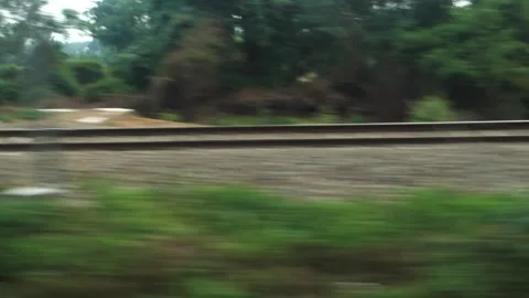 Parallel tracks running along a speeding Train with trees and electric pole.. Stock-Footage 243559234