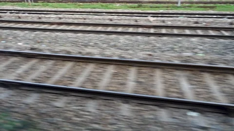 Parallel tracks running along a speeding Train with trees and electric pole.. Stock-Footage 243559322