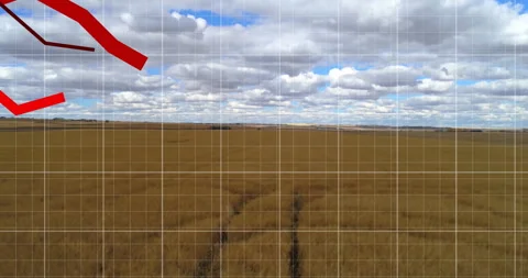 Parallel tractor tire tracks stretching across golden field under moving clouds Stock Footage 308387038