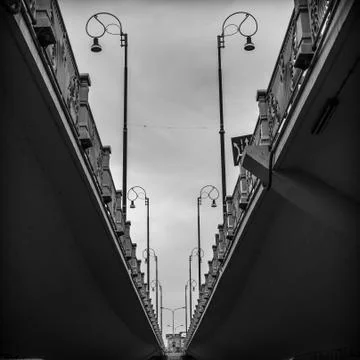 Parallel view under the bridge with dark shadows and street lights Stock Photos