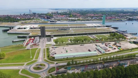 Parallel waterways tall control towers sit within lock complex dense townscape Stock-Footage 327649894