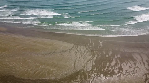 Parallel waves break on the shore, creating a repeating pattern Stock Footage 283265837