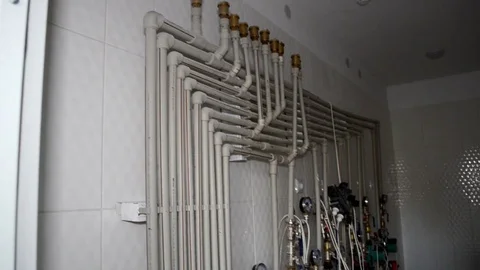Parallel wiring of plastic pipes for water in an apartment building with meters Stock Footage 106410100