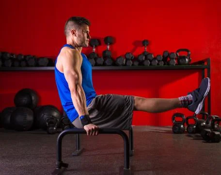 Parallettes man parallel bars workout at gym Stock Photos