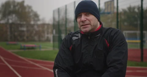 Paralympian man with disabilities not functioning legs look looking at camera Stock Footage 154255594