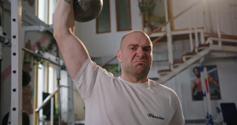 Paralympian with non-functioning legs man sitting in a wheelchair in the gym Stock Footage 154256855