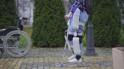 Paralyzed man learns to walk again with robotic exoskeleton Stock Footage 118612816