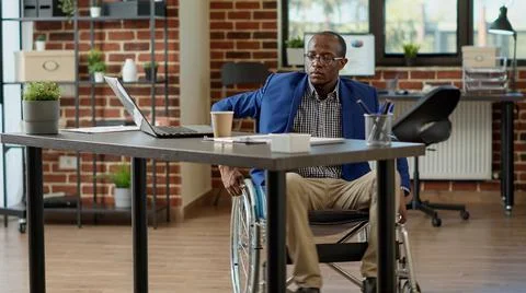 Paralyzed worker with physical disability analyzing statistics 스톡 사진
