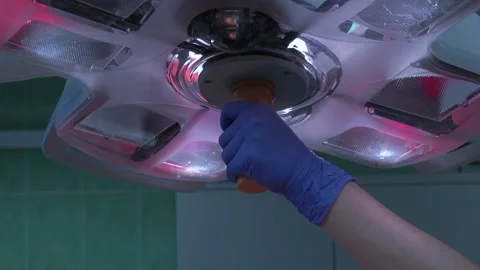 The paramedic adjusts the operating lamp Stock Footage 142091095