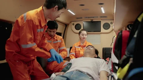 Paramedic are saving lives by providing oxygen and pumping the heart Stock Footage 197329680