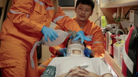 Paramedic are saving lives by providing oxygen and pumping the heart Stock Footage 197329696