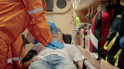 Paramedic are saving lives by providing oxygen and pumping the heart Stock Footage 197329830