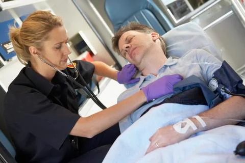Paramedic attending to patient in ambulance Stock Photos