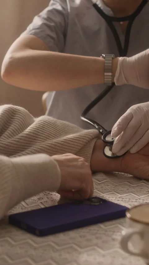 Paramedic Checking Pulse and Looking at Watch Stock Footage 335880243