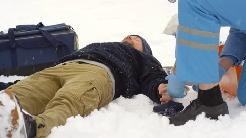 Paramedic Checking Pulse of Unconscious Patient Stock Footage 123688596