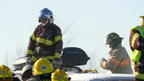 Paramedic with cool silver reflective protective helmet stands on car in Video stock 125168269