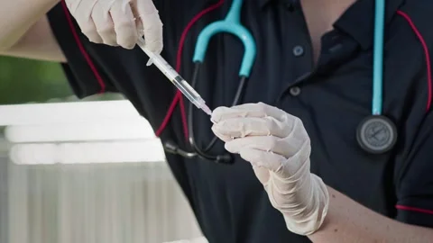 Paramedic Demonstrates Syringe Preparation During Clinical Skills Training Stock Footage 337704830