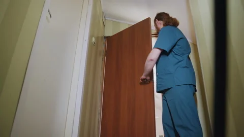 Paramedic examines inside home carefully. Healthcare worker methodically Stock Footage 337557619