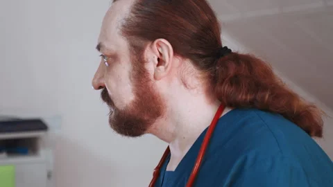 Paramedic examining patient notes calmly. Residential assessment involving Video stock 342337303