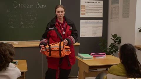 Paramedic Explaining Gear and Uniform to Kids in Class Stock Footage 328327898